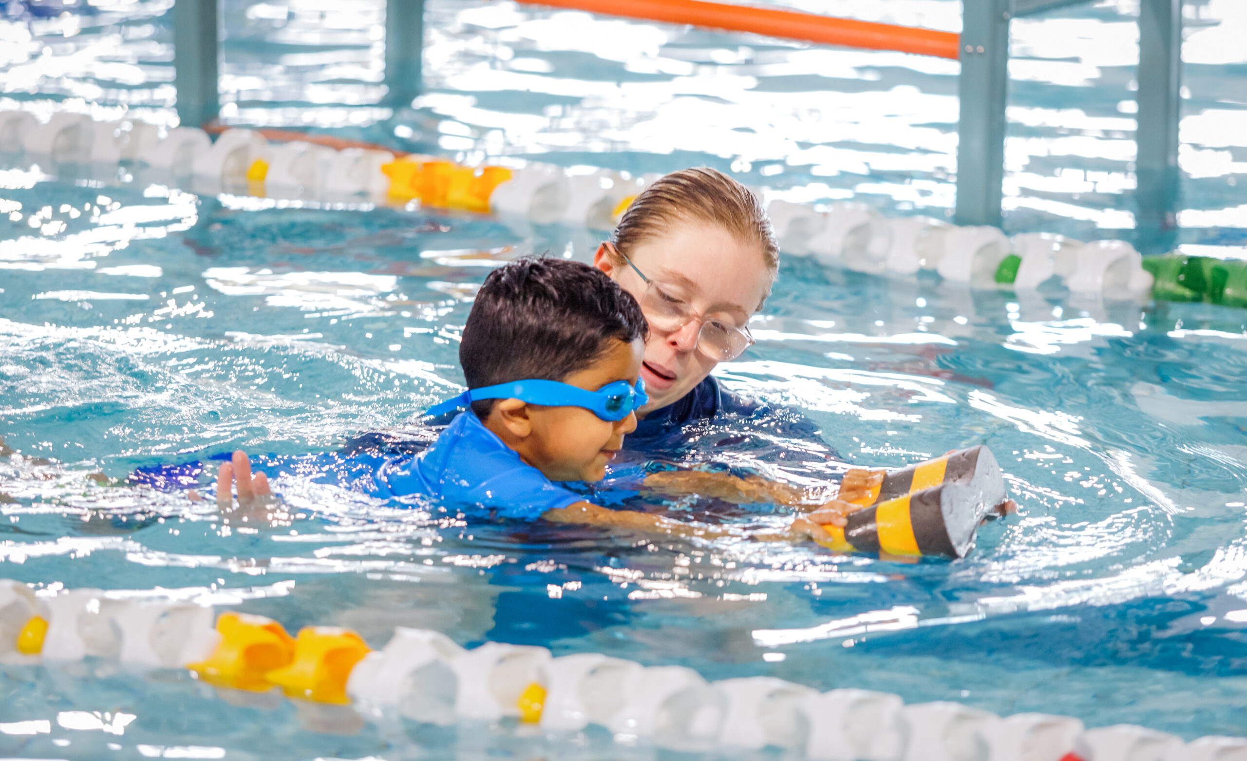 swimming teacher teaching children